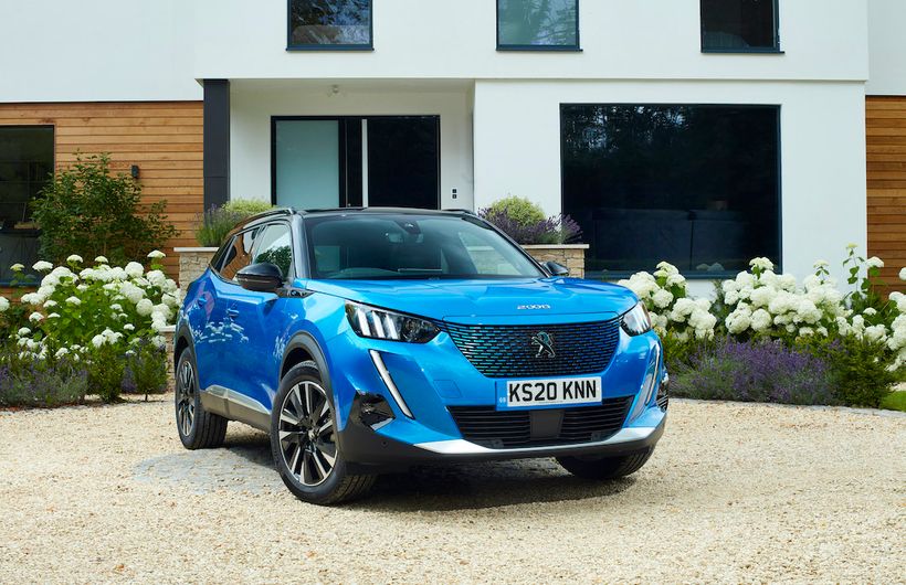 Peugeot E2008 electric car parked in driveway